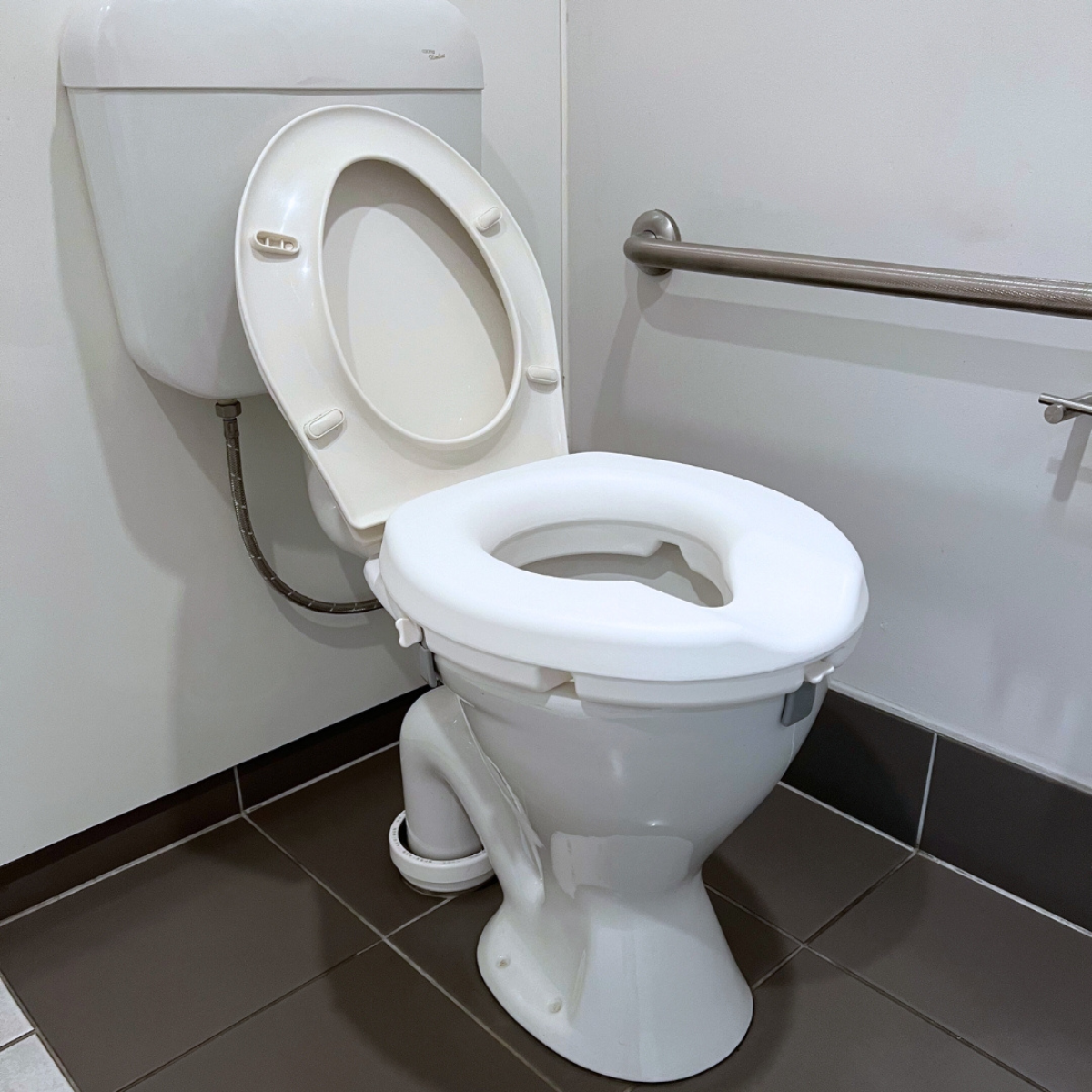 Raised toilet seat with armrests