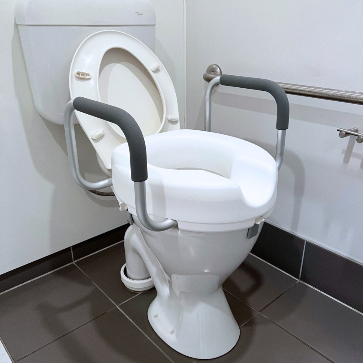 Raised toilet seat with armrests