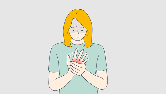 Woman holding hand that throbs red - arthrtic pain illustration
