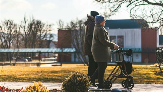 Couple walking with rollator in winter