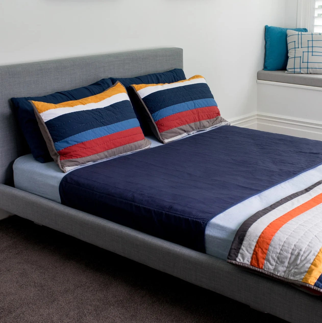Navy brolly sheets with flaps on a double bed