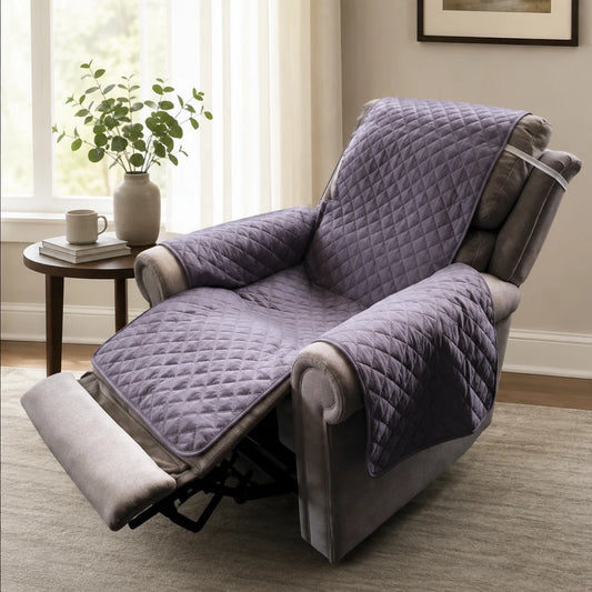 Brolly sheets recliner protector with arms on a chair in the reclined position with a side table, flowers, mug and books beside it