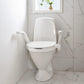 Etac My-loo raised toilet seat with armrests next to wall in bathroom