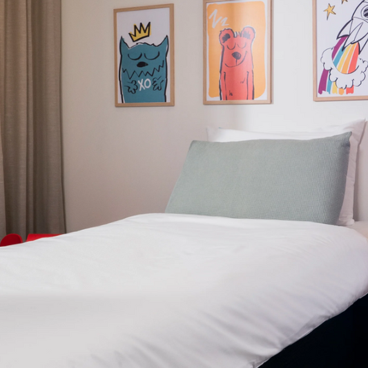Bedroom with a bed featuring a duvet protector